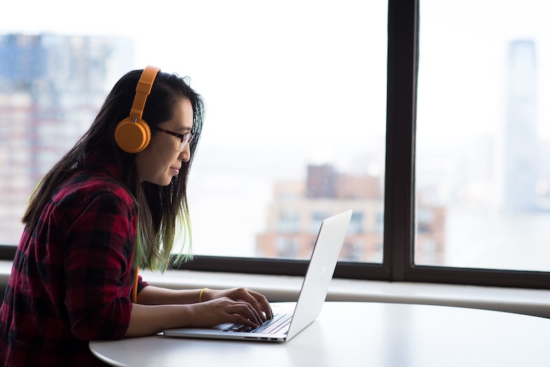 Student wearing headphones and working on laptop