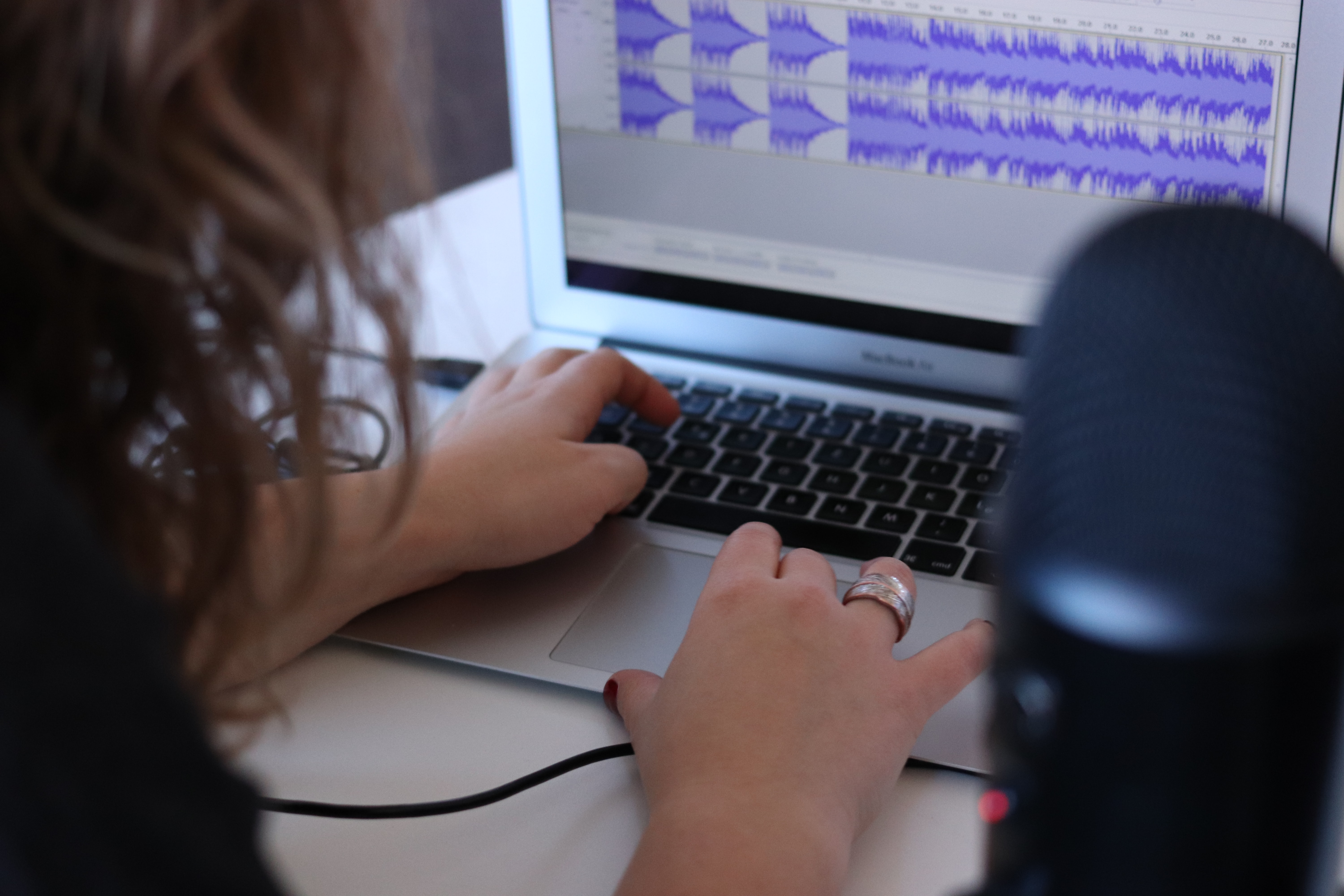 person editing a recording on a laptop