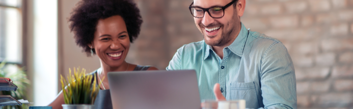 image of two people working together on a laptop