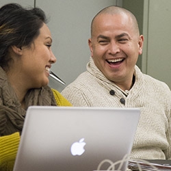 smiling students with laptop