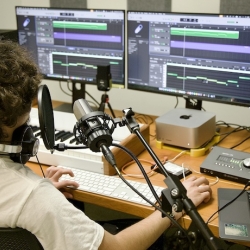 a student using the audio mixing station