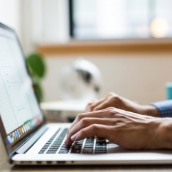 person typing on keyboard