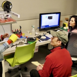 three students using the fabrication station