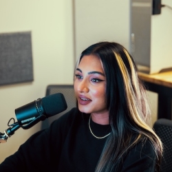 person using a podcasting microphone