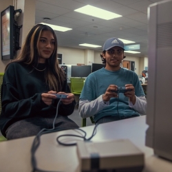 two people playing video games on a Nintendo NES